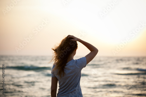 beautiful  girl at sunset on the sea © KseniyaK