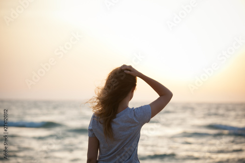 beautiful girl at sunset on the sea