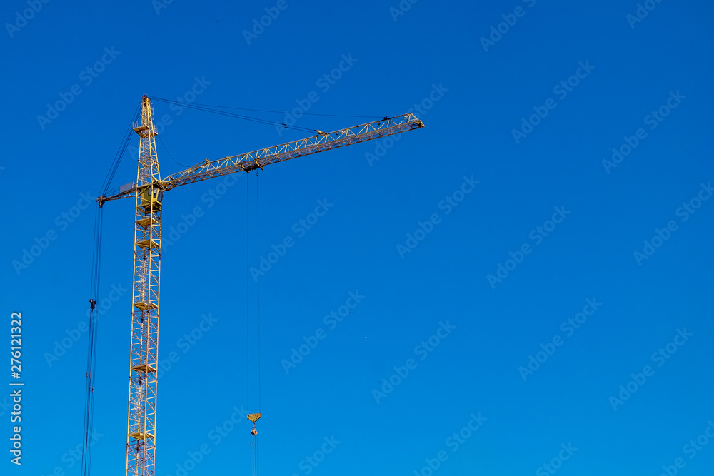 Tower crane over clear blue sky. Space for text Tower crane over clear blue sky. Space for text