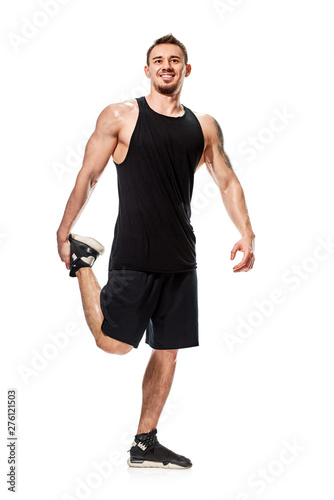 Happy athletic man stretching leg before training, full photo © Denys Kurbatov