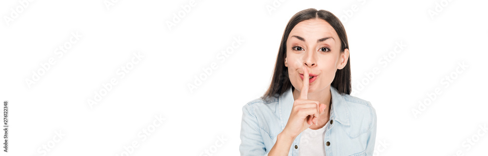 brunette woman showing hush sign isolated on white, panoramic shot brunette woman showing hush sign isolated on white, panoramic shot