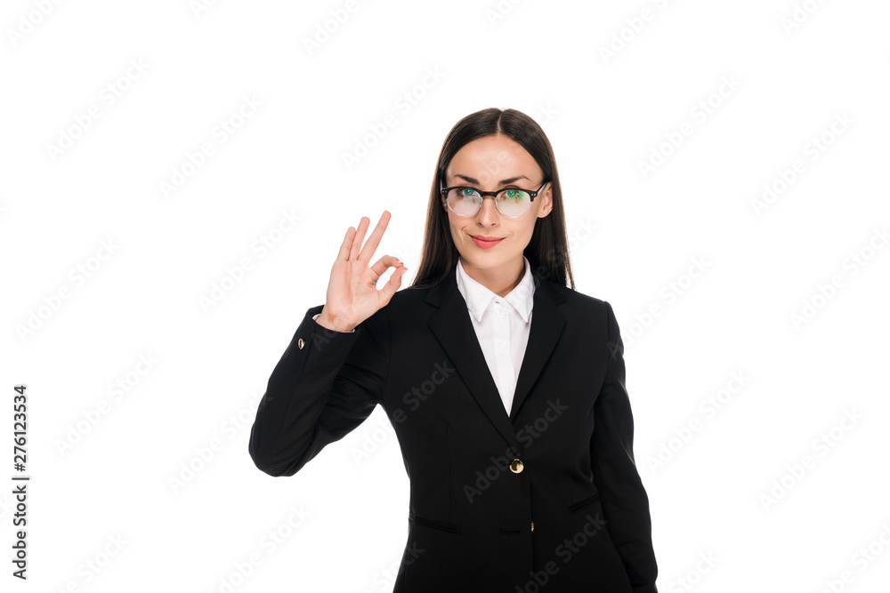 smiling businesswoman in black suit showing ok sign isolated on white smiling businesswoman in black suit showing ok sign isolated on white