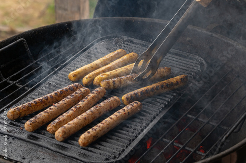 Cooking sausages on the barbecue grill. Grilled sausages