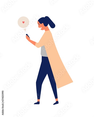 Happy young woman chatting or texting on smartphone while walking. Cute funny...