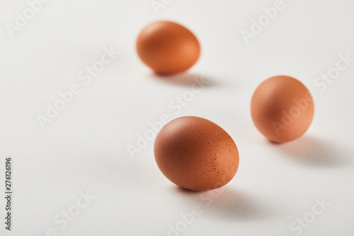 selective focus of chicken eggs on white surface