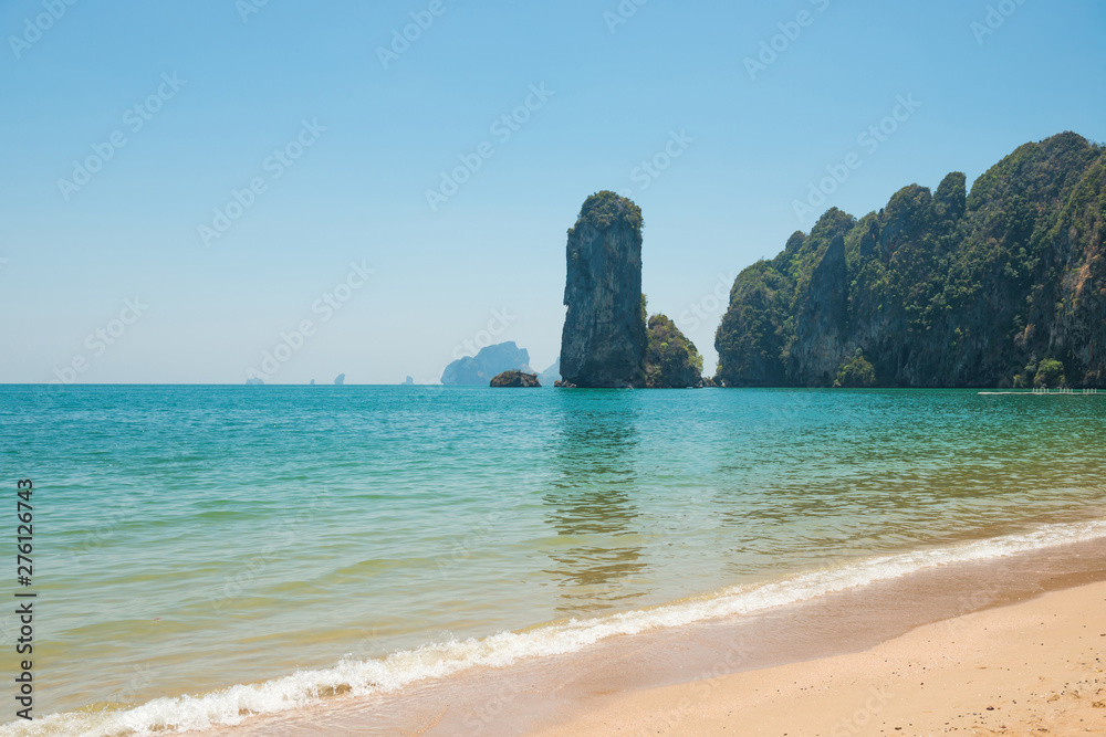 Tropical landscape with sand beach, turquoise sea and rocky coast. Ao Nang, Thailand