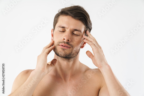 Close up of a handsome young shirtless man isolated