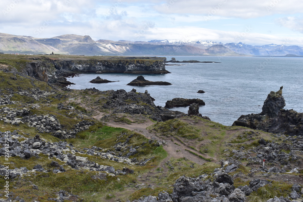 Hiking trail from Anarstapi to Hellnar with the raw ocean und big rocks ...