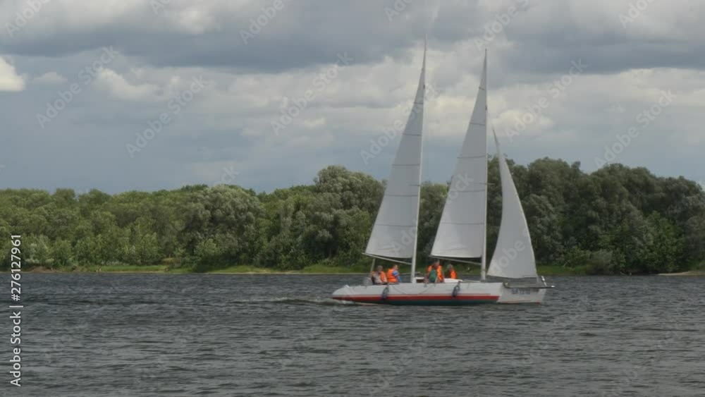 yacht catamaran with sails on a picturesque lake yacht catamaran with sails on a picturesque lake