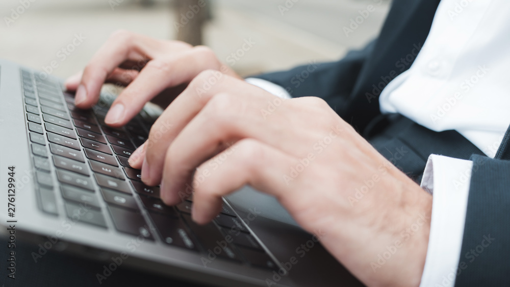 Close-up of businessman's hand typing on laptop Close-up of businessman's hand typing on laptop