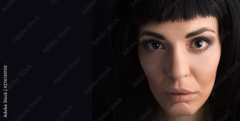 Fototapeta premium Portrait of a reflective woman, studio shot.