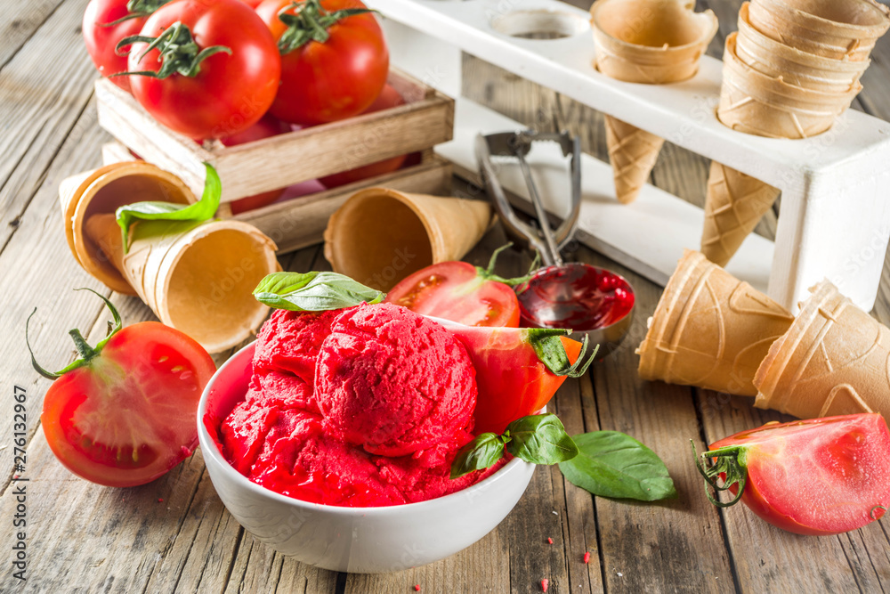 Vegetable gelato. Tomato ice cream with fresh tomatoes and basil and leaves, old rustic wooden background. Vegetable gelato. Tomato ice cream with fresh tomatoes and basil and leaves, old rustic wooden background.