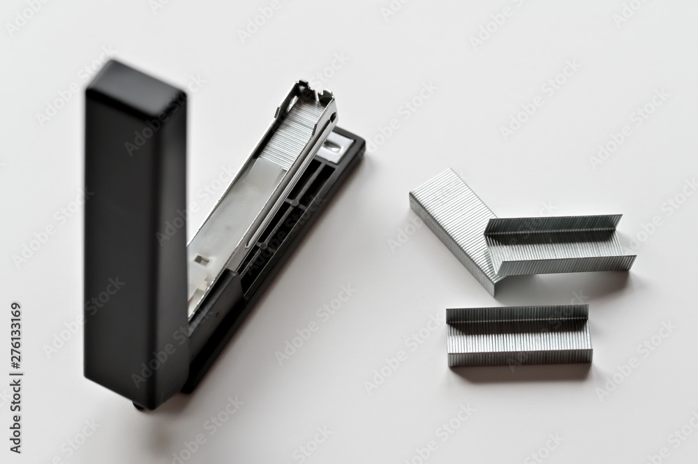 Stapler black with paper clips isolated on white background. Stapler black with paper clips isolated on white background.