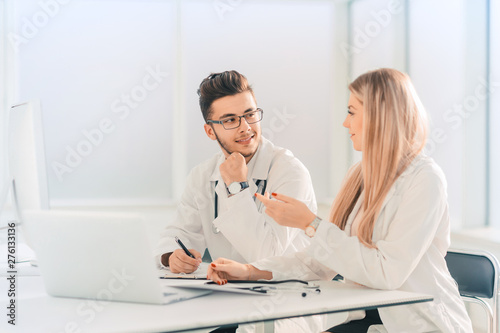 doctors colleagues talking sitting at a table in the office
