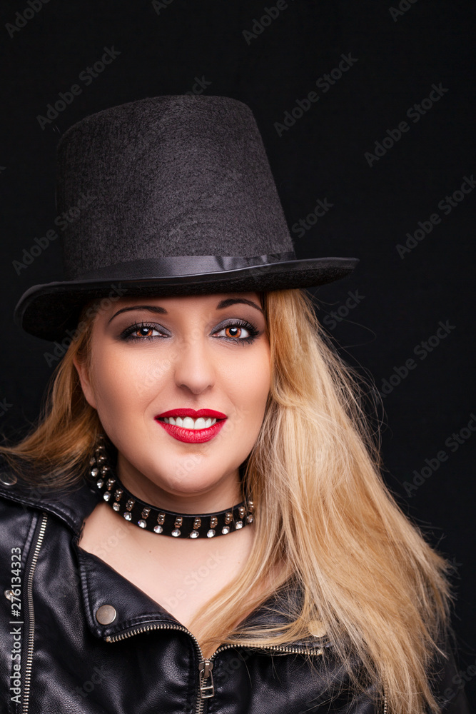 Beautiful blonde girl in rock style on a black background. Beautiful blonde girl in rock style on a black background.
