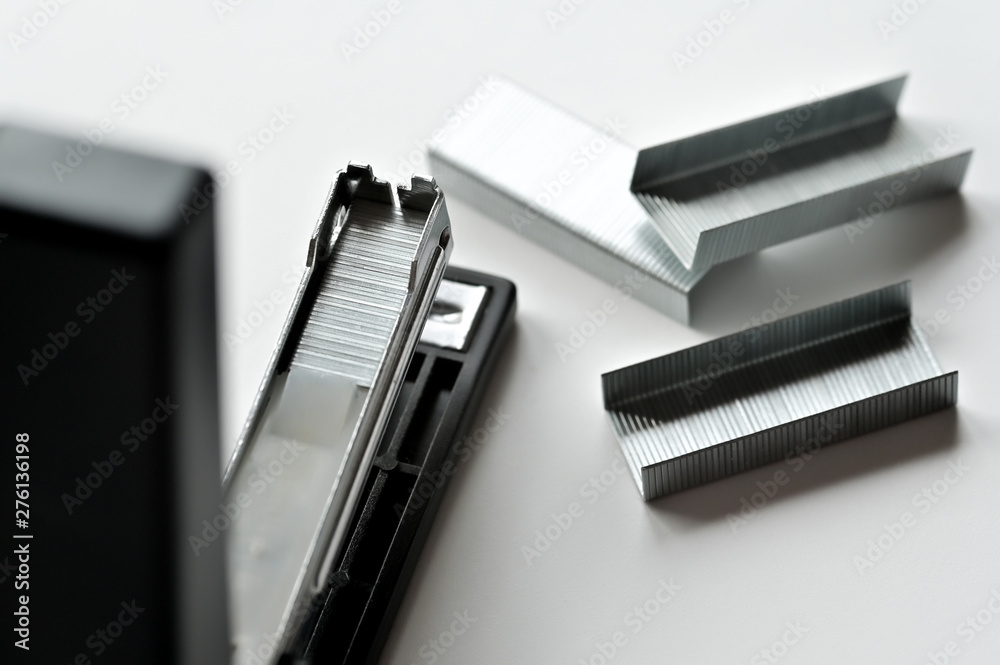 Stapler black with paper clips isolated on white background. Stapler black with paper clips isolated on white background.
