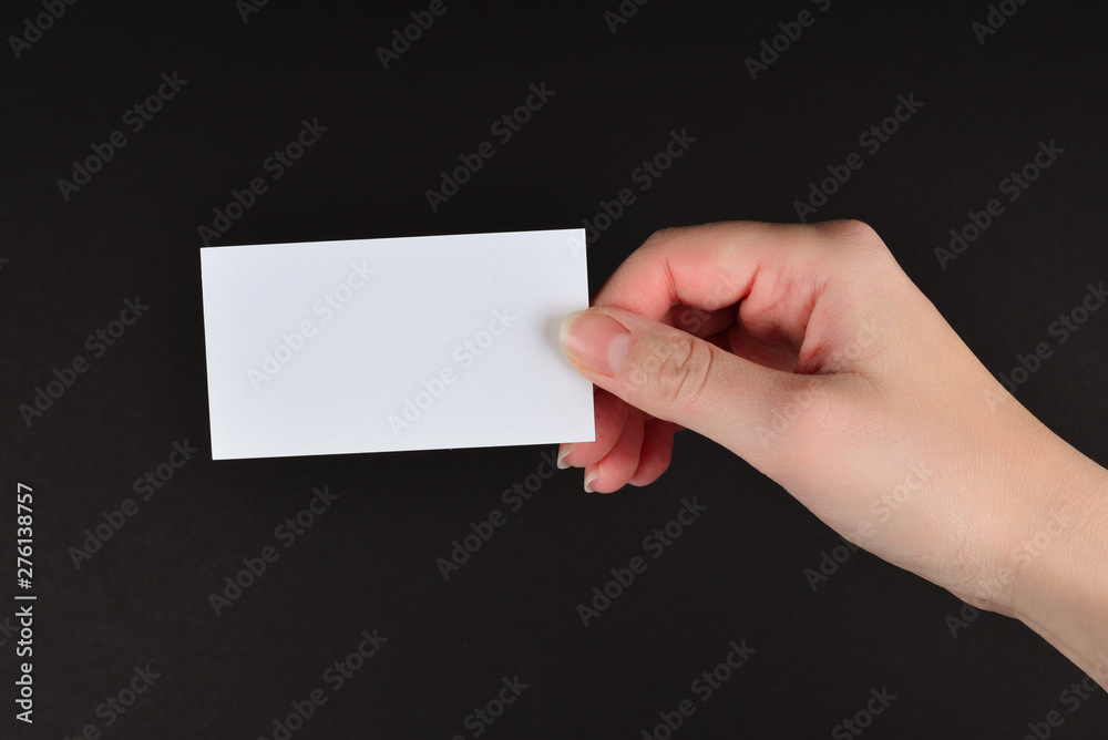 Empty card in woman hand on a black background. Empty card in woman hand on a black background.