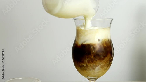 Putting whipped cream foam to make iced cafe einspanner (viennese coffee)