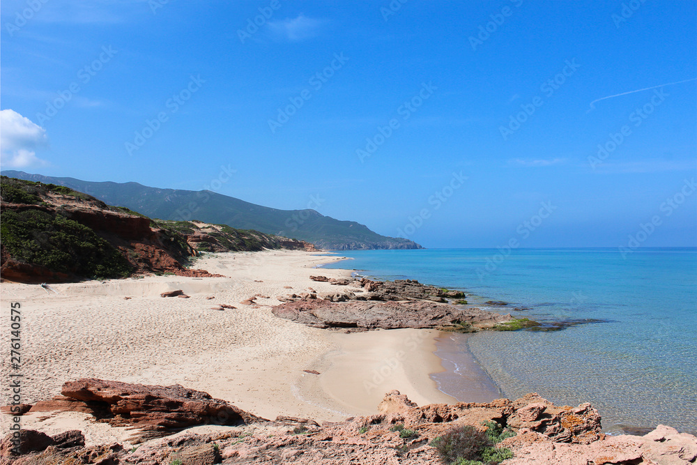 Nice beach with some rocks and the blue ocean in sardinia.