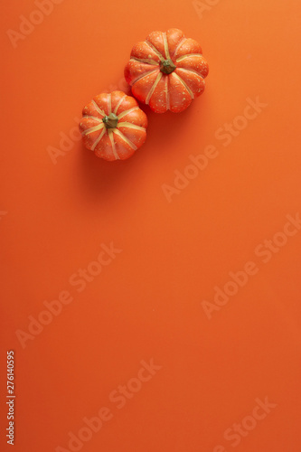 Pumpkins decorations on orange paper