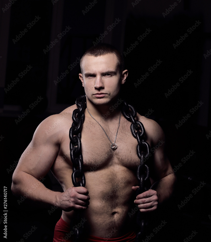 portrait of a handsome male bodybuilder with a chain around his neck