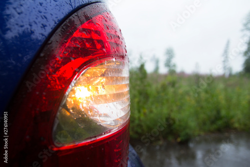 Car in the rain. Headlights front rear windshield.