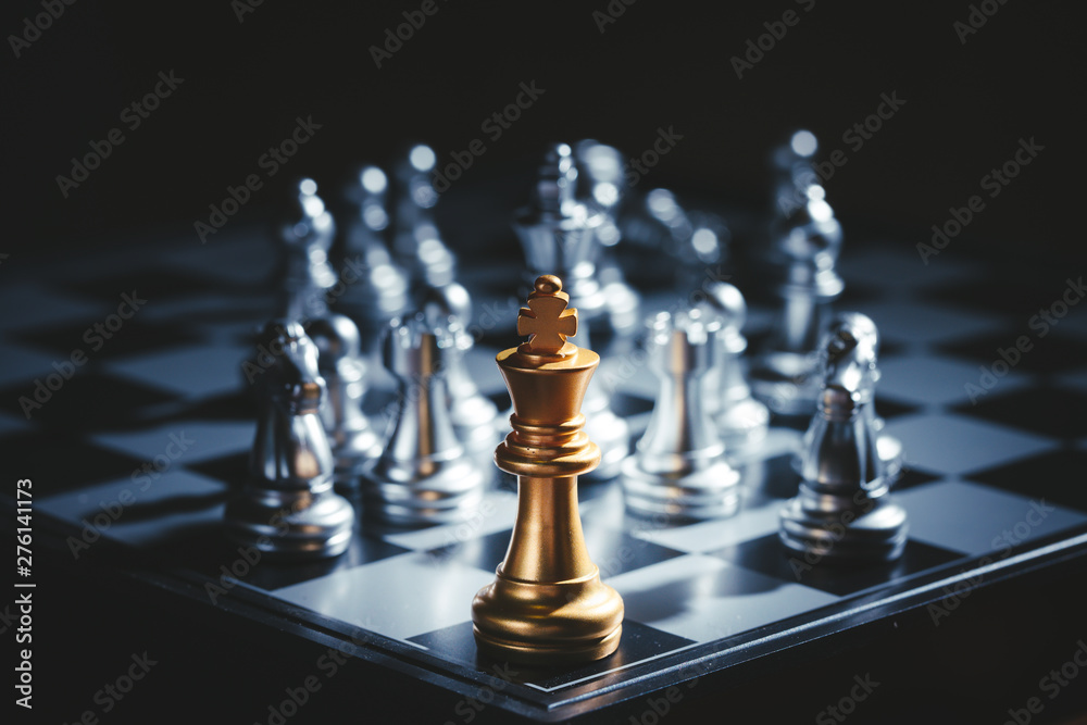 One king chess pieces staying against full set of chess pieces on black background.Strategy,Decision and Planning concept.