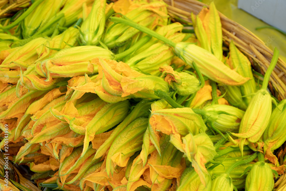 Fresh zucchini flower or courgettes in a farmer agricultural open air market, seasonal healthy food. Concept of biological, bio products, bio ecology, grown by yourself, vegetarians Fresh zucchini flower or courgettes in a farmer agricultural open air market, seasonal healthy food. Concept of biological, bio products, bio ecology, grown by yourself, vegetarians
