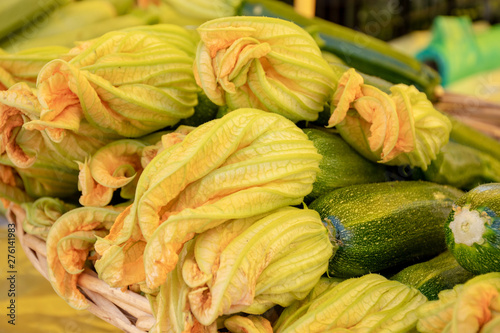 Fresh zucchini flower or courgettes in a farmer agricultural open air market, seasonal healthy food. Concept of biological, bio products, bio ecology, grown by yourself, vegetarians