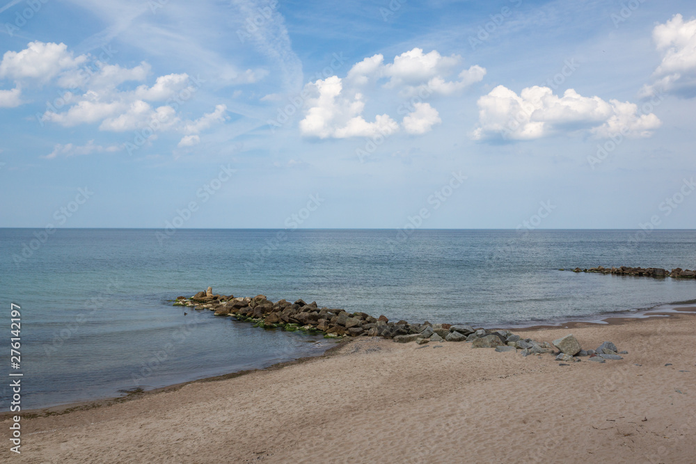 Landscape with beach and breakwaters at sunny day in Niechorze, Zachodniopomorskie, Poland