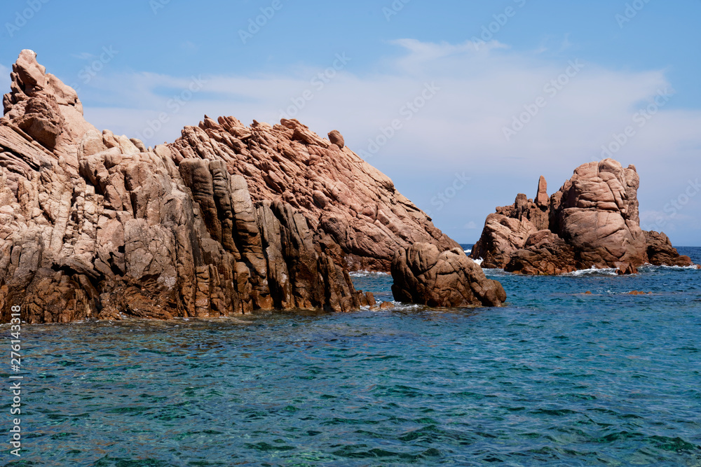 Rugged rock formation at a turquoise beach at La Sorgente, Costa Paradiso in Sardinia (Italy) with turquoise blue sea