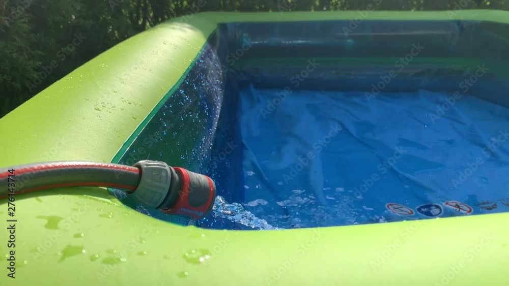[Tilt] Pool being filled by garden hose. Filling inflatable pool with