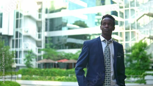 Wallpaper Mural African American businessman wearing blue suit standing near office. Business concept Torontodigital.ca
