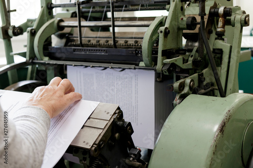 Tableau sur toile Machine for stitching book pages with threads in typography.
