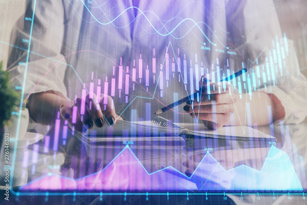 Financial forex graph drawn over hands taking notes background. Concept of research. Double exposure Financial forex graph drawn over hands taking notes background. Concept of research. Double exposure