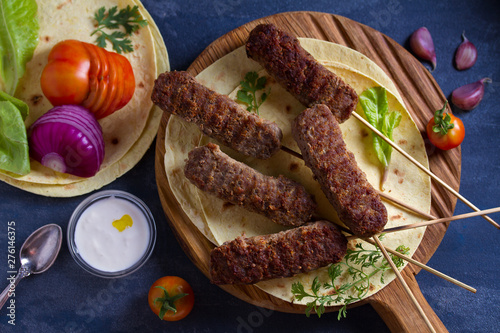 Kofta kebabs with pita bread, vegetables and yogurt sauce