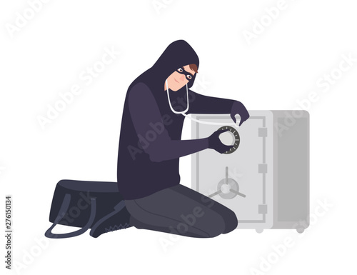 Male burglar wearing mask and hoodie using stethoscope to open safe or strongbox