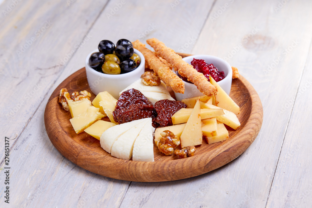 cheese plate with olives - obrazy, fototapety, plakaty 