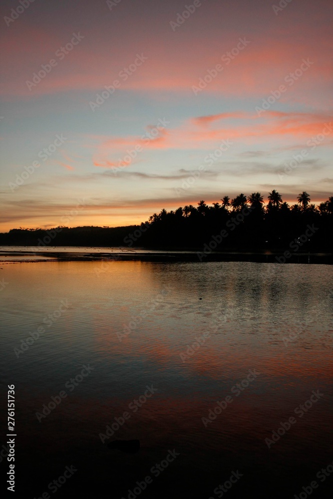 Obraz premium CALM WATERS ON SUNRISE AT NIAS INDONESIA, VERTICAL