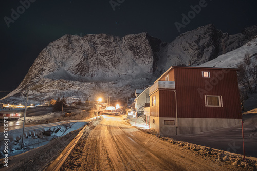 Norwegian village on country road with light shining and snow mountain range © Mumemories
