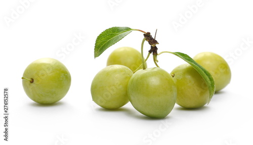 Wild yellow plums with leaves and twigs, isolated on white background