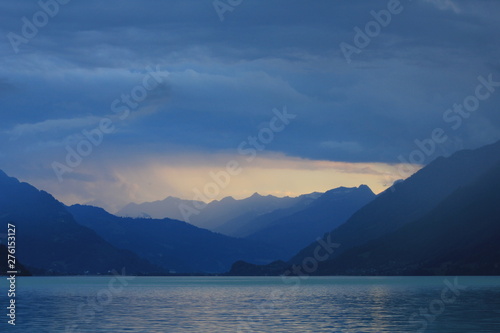 Summer scene at Lake Brienz. Last sunlight of the day and thunderstorm over Interlaken, Switzerland.