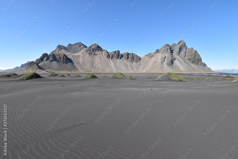 Fototapeta premium Beautiful view of the Vestrahorn Mountains with black sand in front near Höfn in Iceland