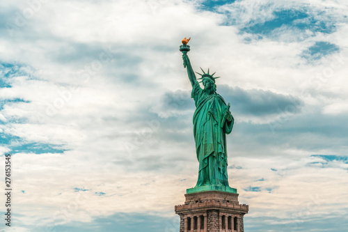 New York City Statue Of Liberty Against Cloudy Blue Sky Background  Copy Space
