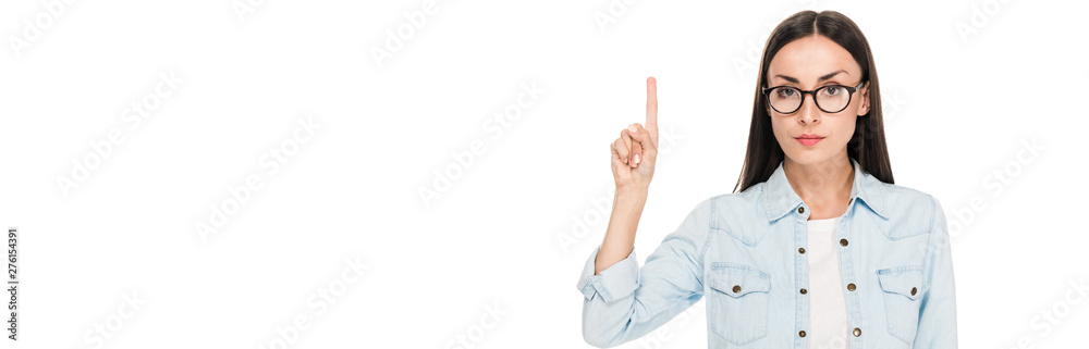 brunette girl in glasses in denim jacket pointing with finger upwards isolated on white, panoramic shot brunette girl in glasses in denim jacket pointing with finger upwards isolated on white, panoramic shot