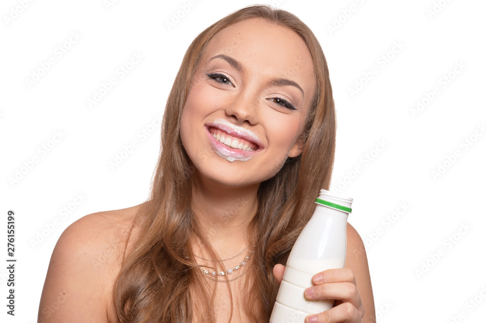 Portrait of a beautiful young woman with milk on white background Portrait of a beautiful young woman with milk on white background