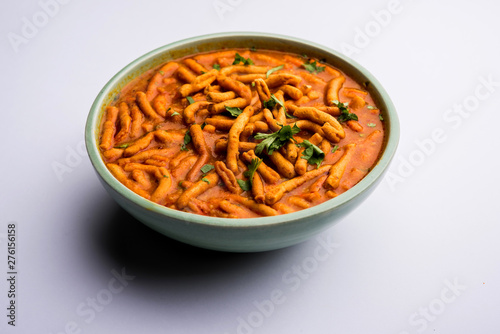 Dhaba style Sev bhaji/sabzi/curry made in tomato curry with gathiya shev, served in a bowl or karahi, selective focus