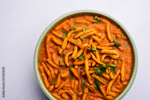 Dhaba style Sev bhaji sabzi curry made in tomato curry with gathiya shev  served in a bowl or karahi  selective focus