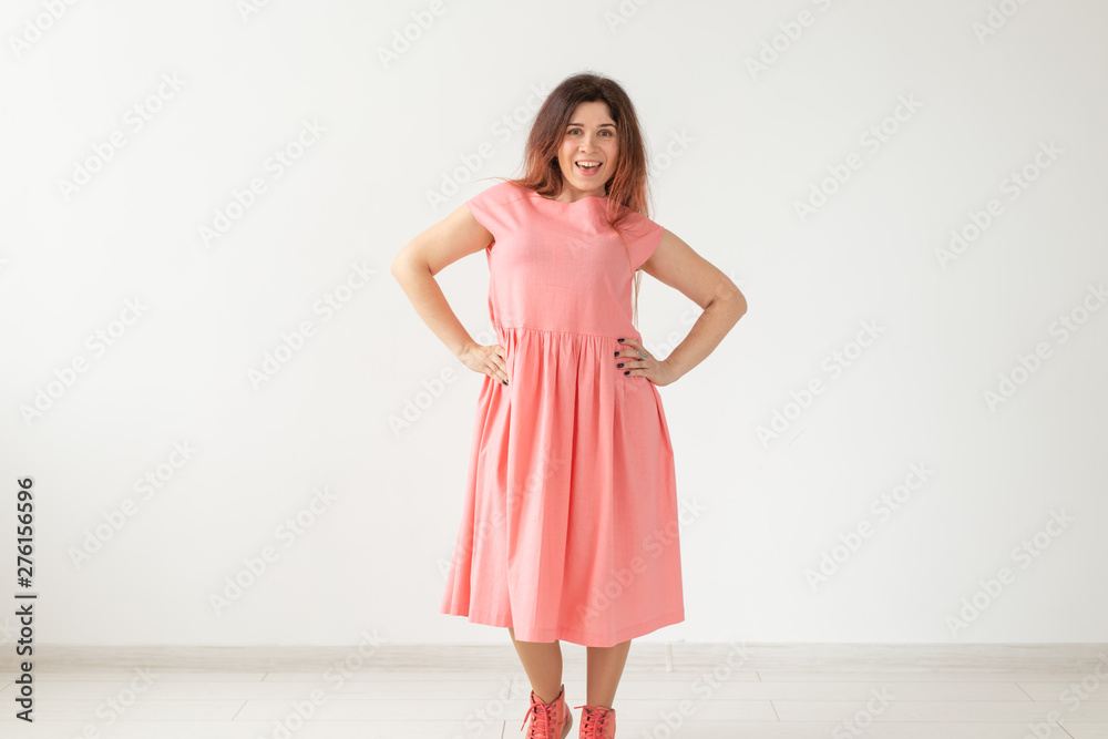 people, fashion and design concept - young woman posing in rose dress on white background with copy space people, fashion and design concept - young woman posing in rose dress on white background with copy space