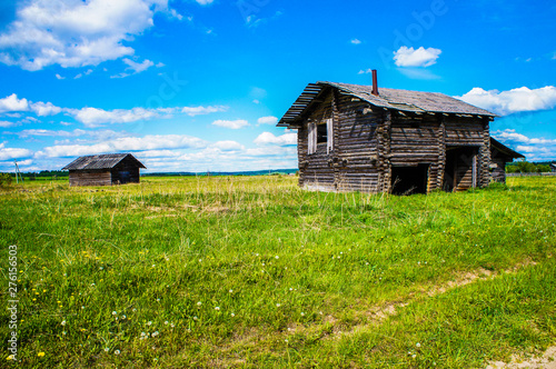old wooden house against the blue sky